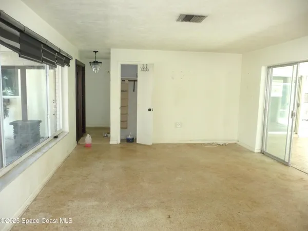 a view of an empty room with glass door