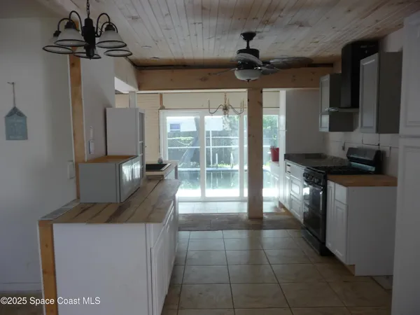 a kitchen with stainless steel appliances granite countertop a sink a stove and a refrigerator
