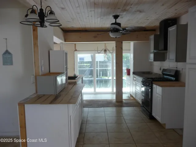 a kitchen with stainless steel appliances granite countertop a sink a stove and a refrigerator