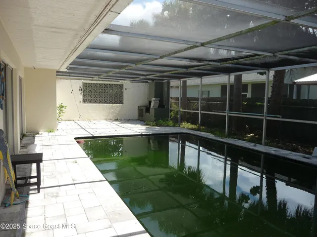 a swimming pool with a table and chairs