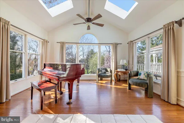 a living room with furniture a table and a large window