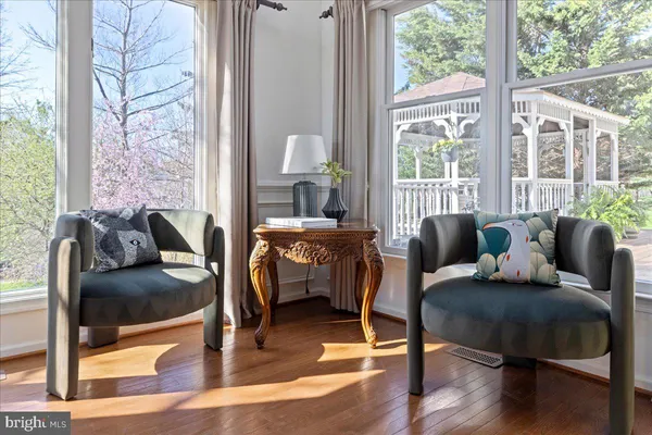 a living room with furniture and a floor to ceiling window