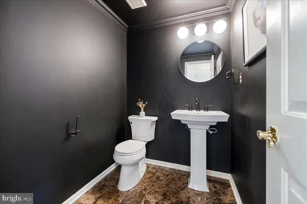 a bathroom with a sink toilet and a mirror