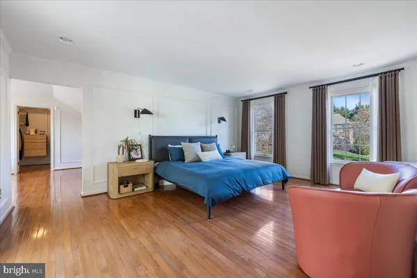 a bedroom with furniture and a large window