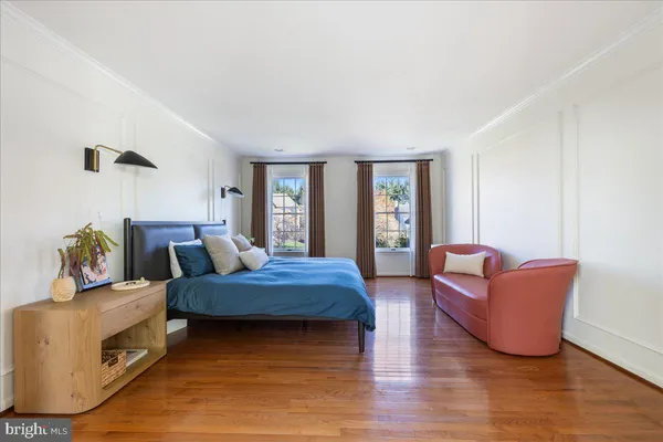 a bedroom with furniture and wooden floor