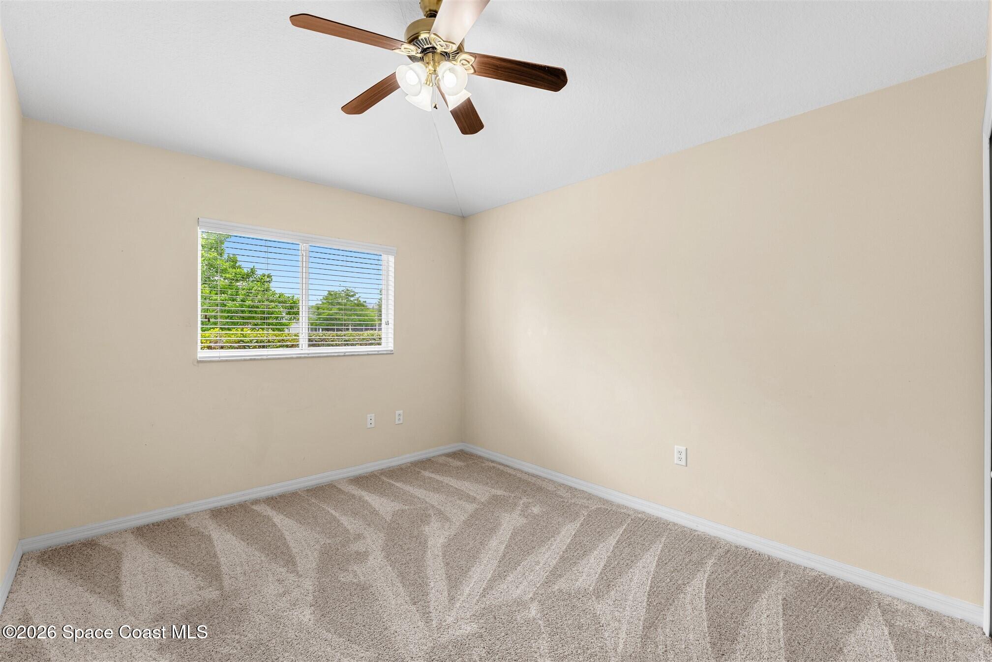 6904 Renshaw Drive Melbourne, FL 32940 - Photo 24 of 46 an empty room with a window and a fan