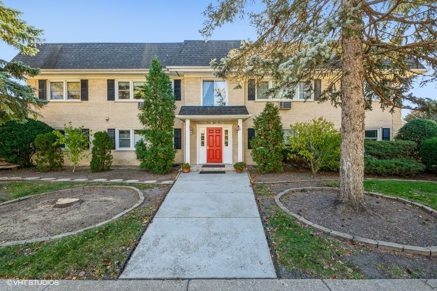 8811 Plainfield Road, Unit 7 Brookfield, IL 60513 - Photo 1 of 10 front view of a house with a yard