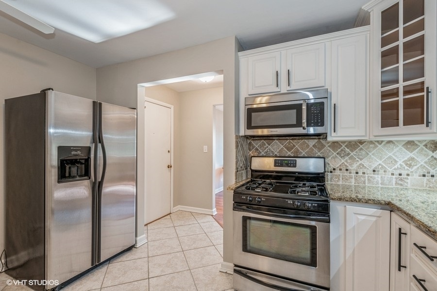 8811 Plainfield Road, Unit 7 Brookfield, IL 60513 - Photo 5 of 10 a kitchen with cabinets stainless steel appliances and a counter space