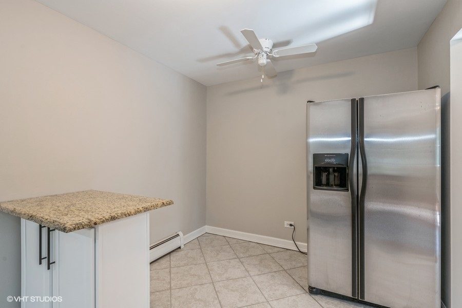 8811 Plainfield Road, Unit 7 Brookfield, IL 60513 - Photo 6 of 10 an empty room with a ceiling fan
