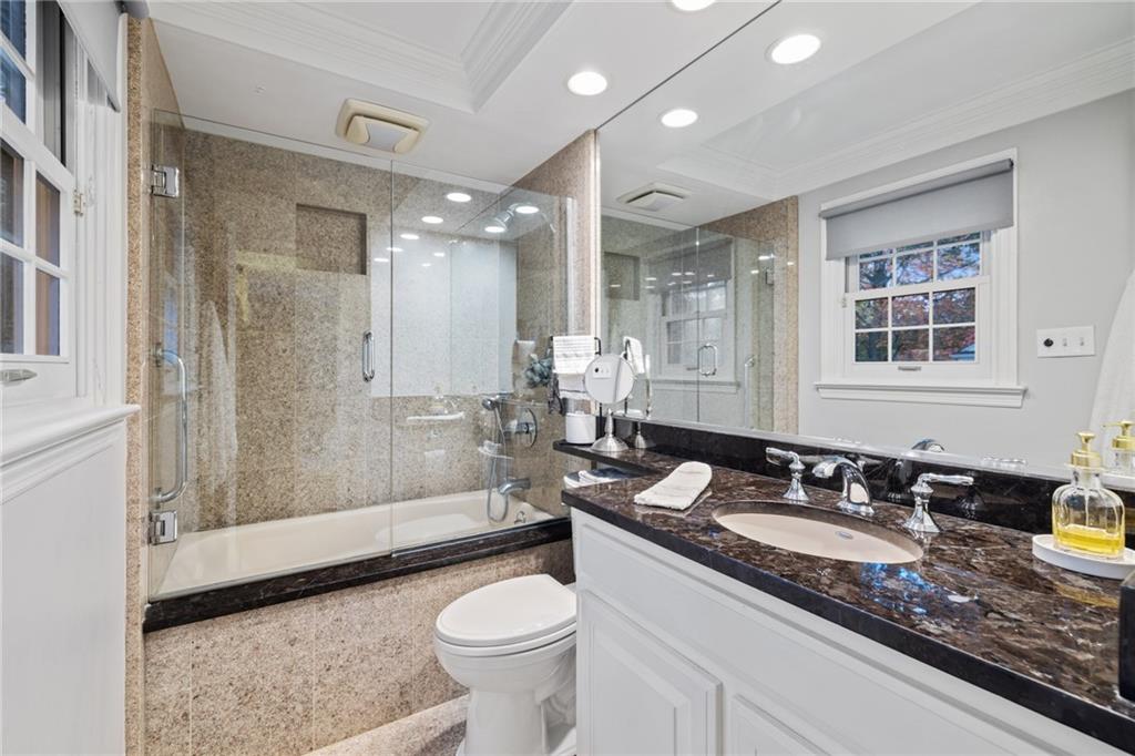 800 Hulton Road Oakmont, PA 15139 - Photo 17 of 25 a bathroom with a granite countertop sink a toilet a mirror and shower