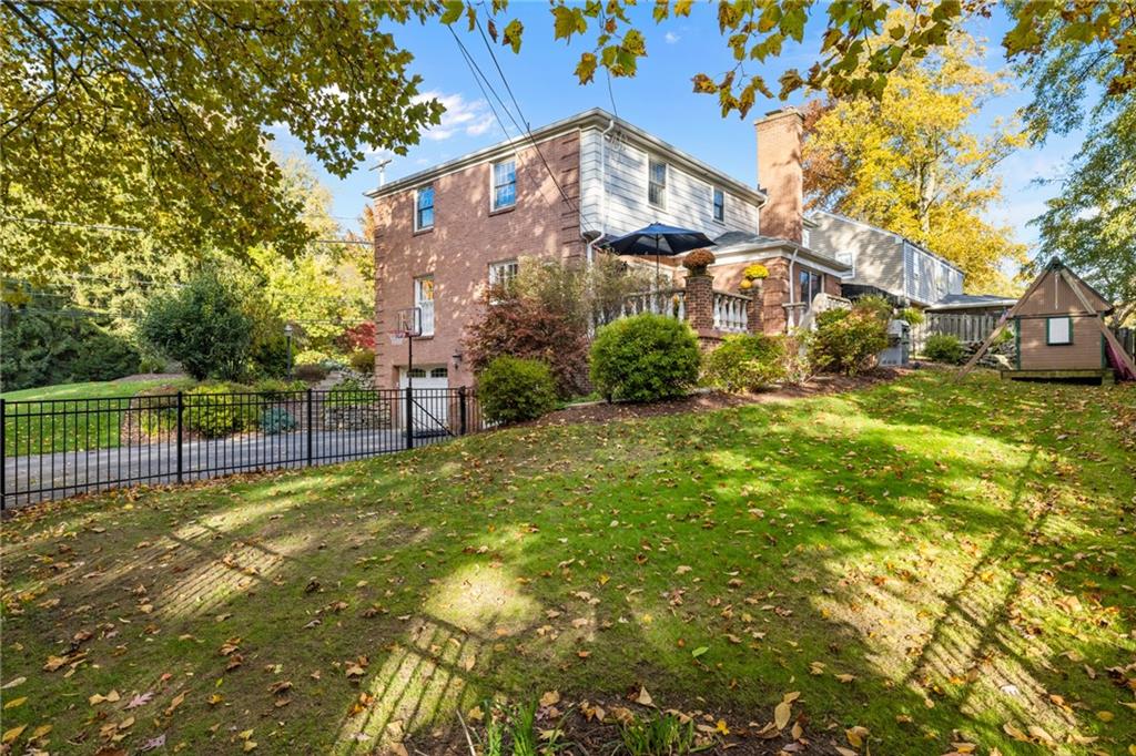 800 Hulton Road Oakmont, PA 15139 - Photo 24 of 25 a view of a brick house with a big yard plants and large trees