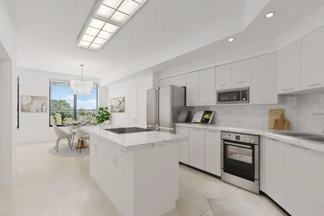 a view of a kitchen with white cabinets