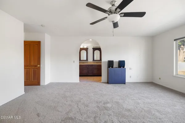 a big room with closet and ceiling fan