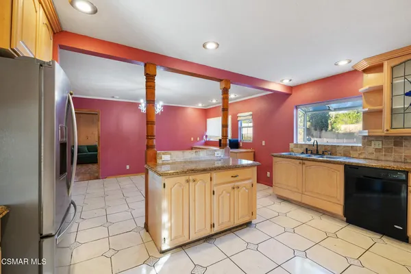 a kitchen with stainless steel appliances granite countertop a sink and cabinets