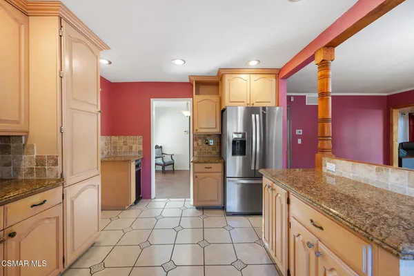 a kitchen with a refrigerator sink and cabinets