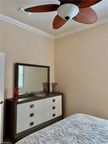 a bedroom with a bed and a mirror