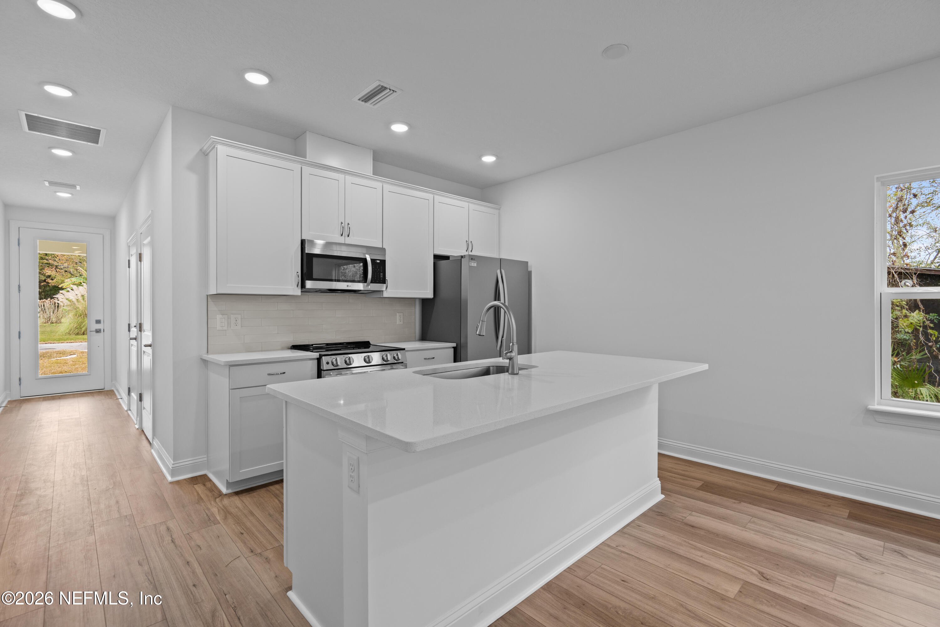 221 Dartmouth Road St. Augustine, FL 32086 - Photo 13 of 24 a kitchen with kitchen island a sink stainless steel appliances and cabinets