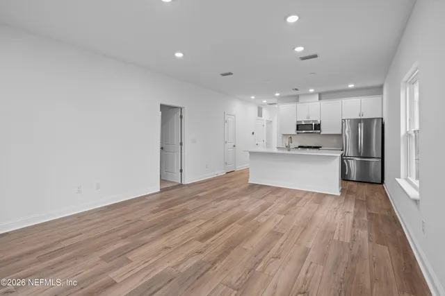 a view of kitchen with wooden floor