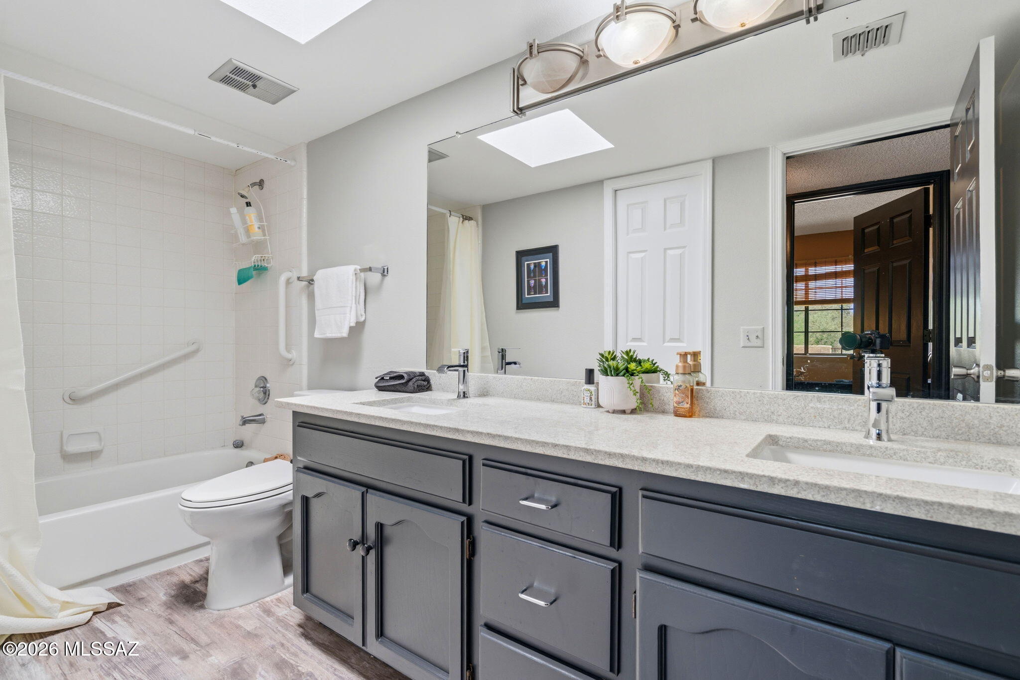 1200 East River Road, Unit G87 Tucson, AZ 85718 - Photo 22 of 30 a bathroom with a granite countertop sink mirror and toilet