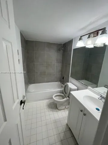 a bathroom with a toilet a sink and bathtub