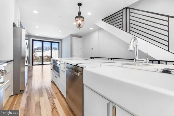a kitchen with granite countertop a sink and a stove top oven