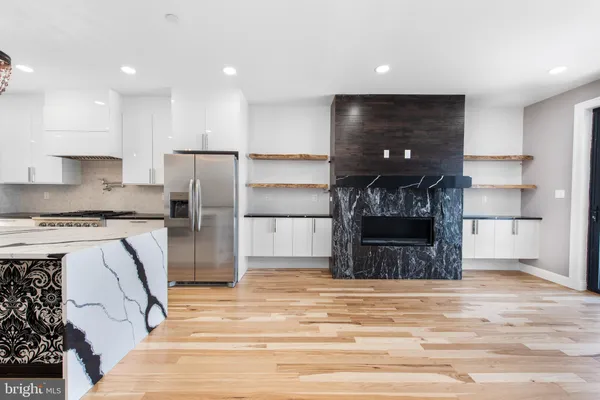 a kitchen with a refrigerator and a stove top oven