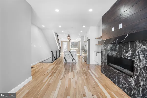 a dining room with furniture and a wooden floor