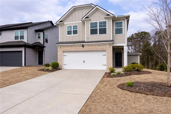 a front view of a house with a yard and garage