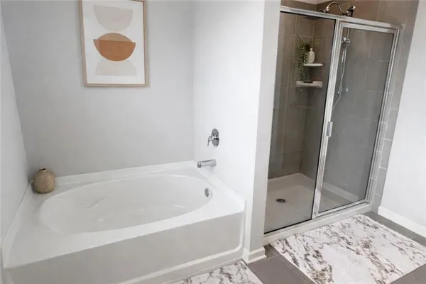 a bathroom with a bathtub and a shower