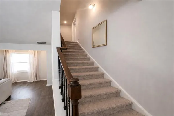 a view of entryway and hall with wooden floor