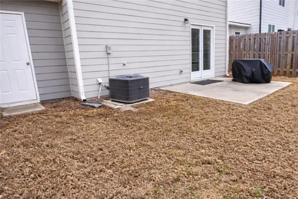 a view of a house with a yard and sitting area