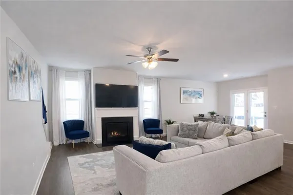 a living room with furniture a fireplace and a flat screen tv