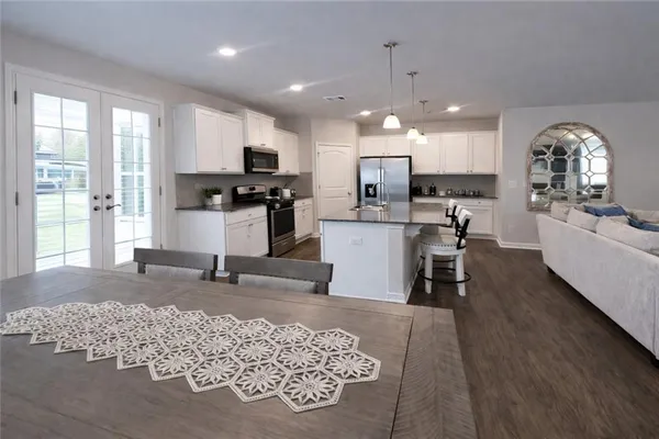 a large kitchen with a table chairs and a refrigerator