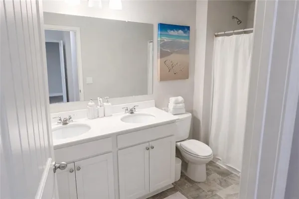 a bathroom with a toilet a sink and a mirror
