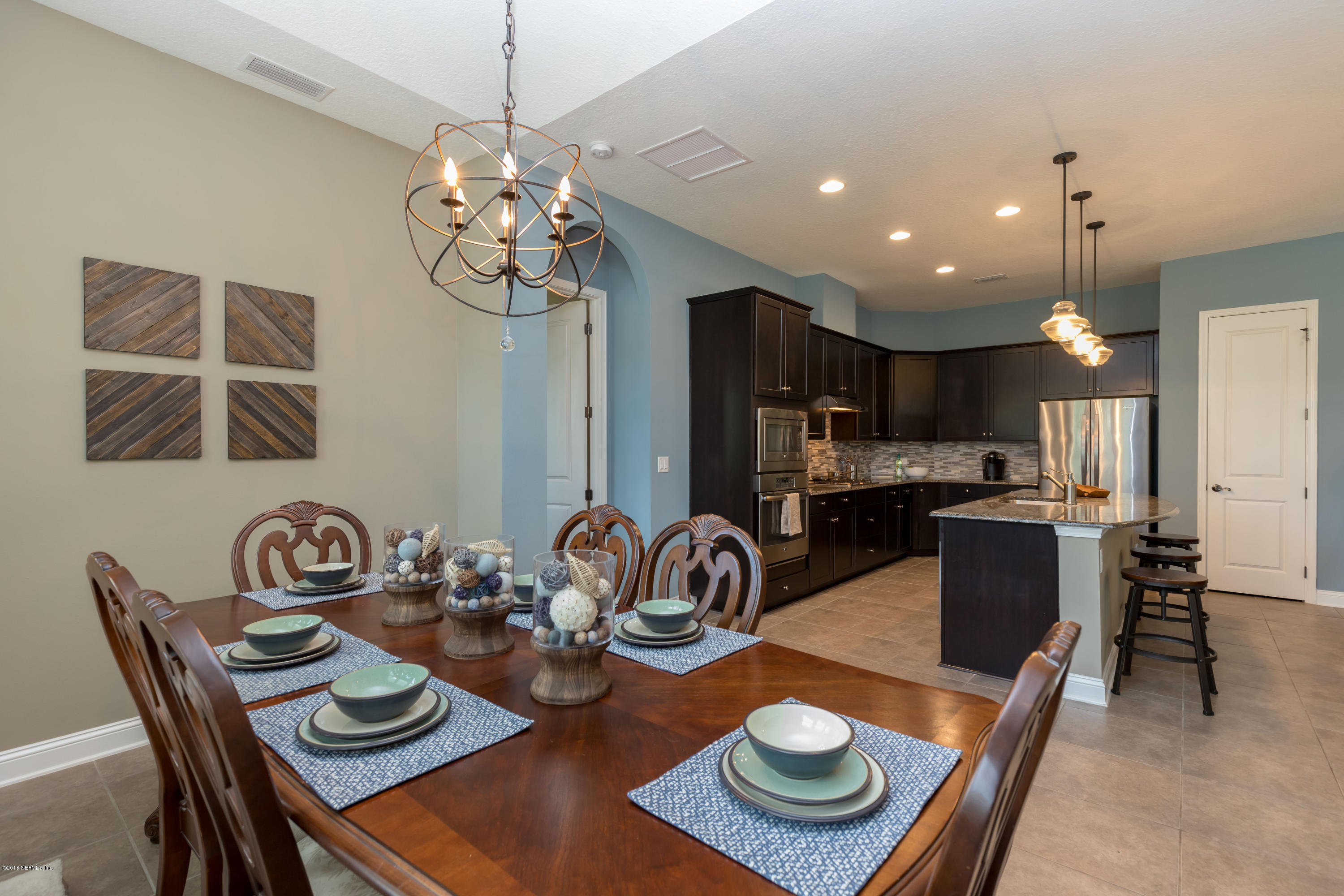 3811 Valverde Circle Jacksonville, FL 32224 - Photo 13 of 42 a kitchen with a dining table and chairs