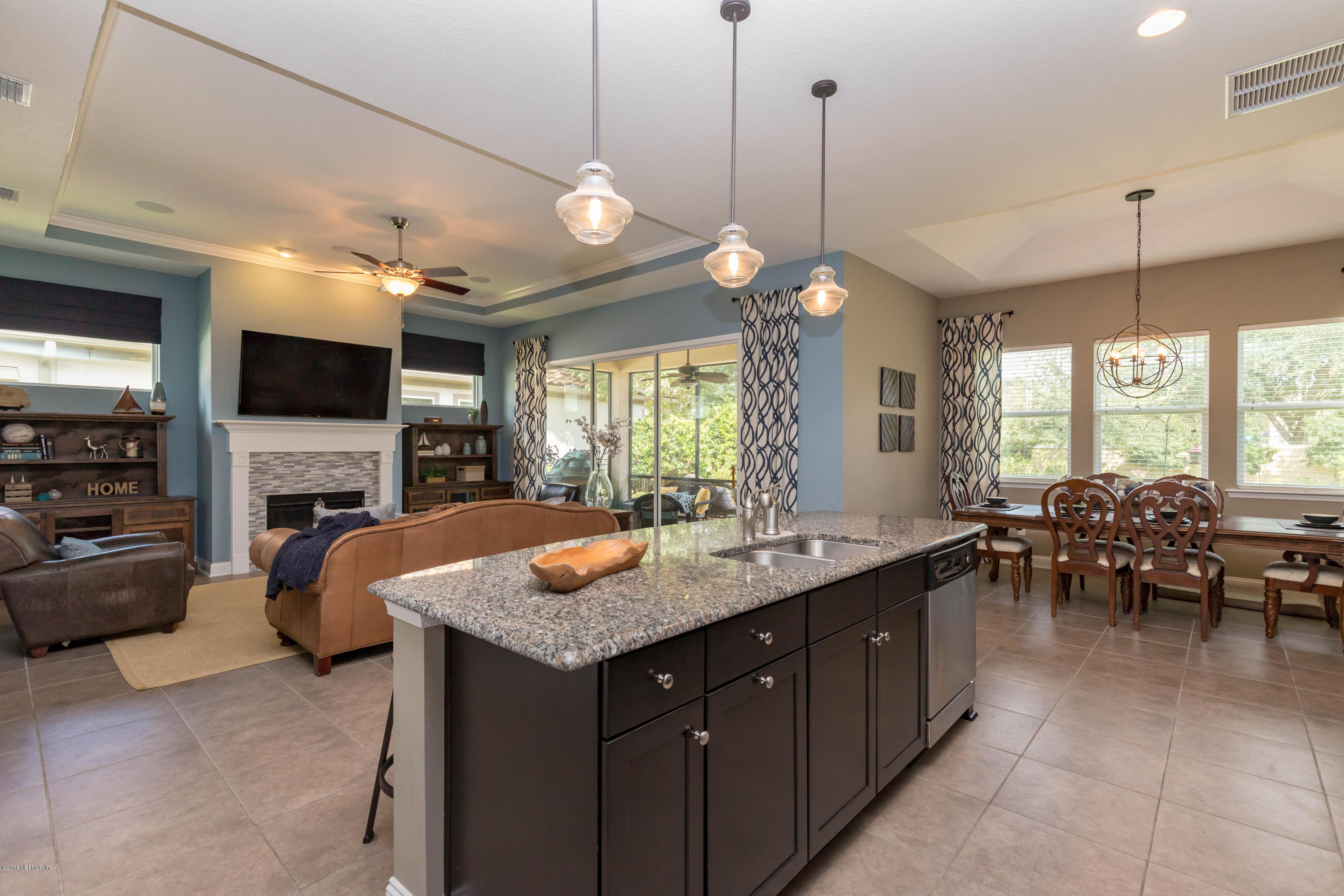 3811 Valverde Circle Jacksonville, FL 32224 - Photo 14 of 42 a kitchen with sink a counter and chairs