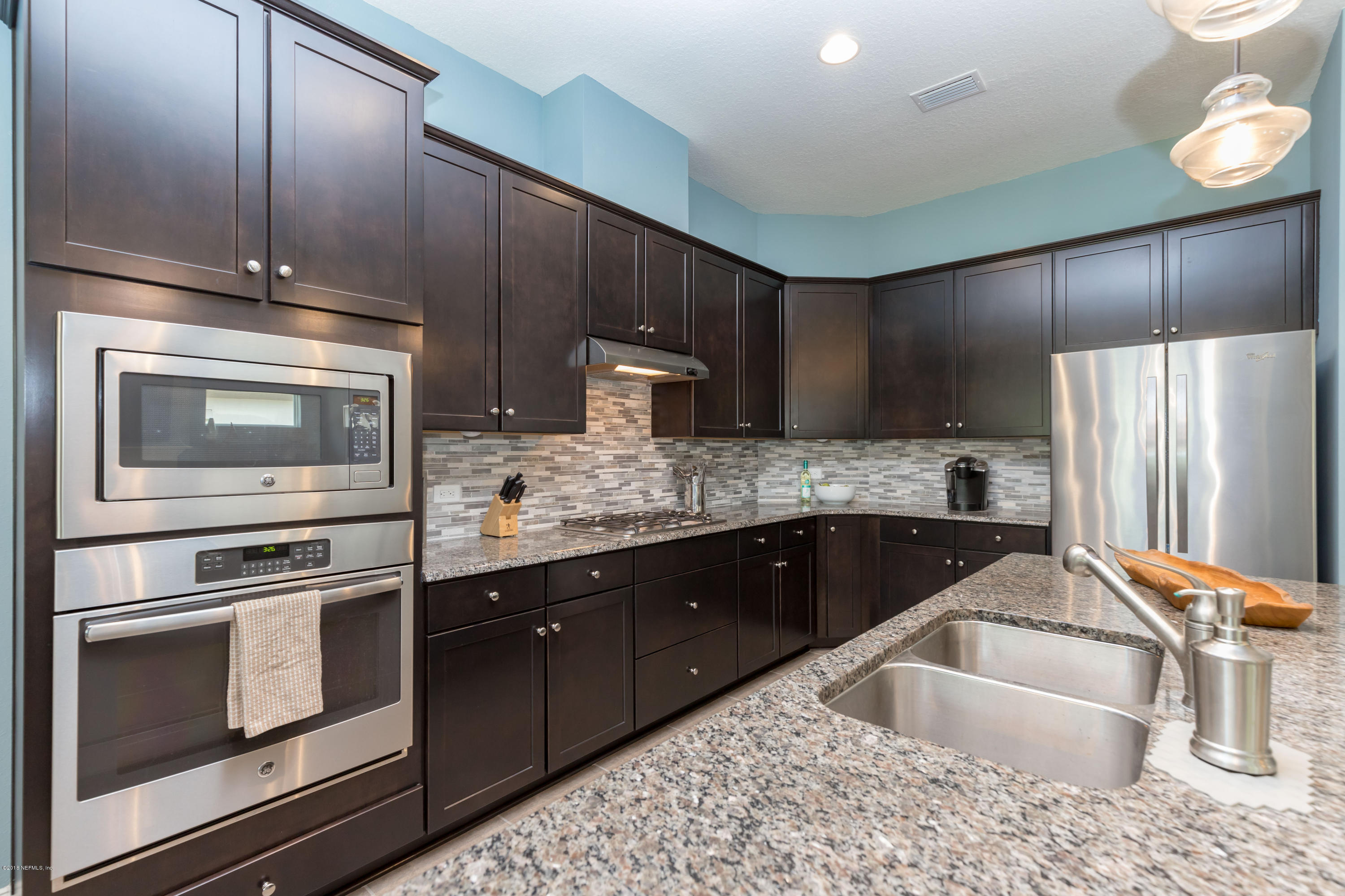 3811 Valverde Circle Jacksonville, FL 32224 - Photo 16 of 42 a kitchen with stainless steel appliances kitchen island granite countertop a sink stove and refrigerator