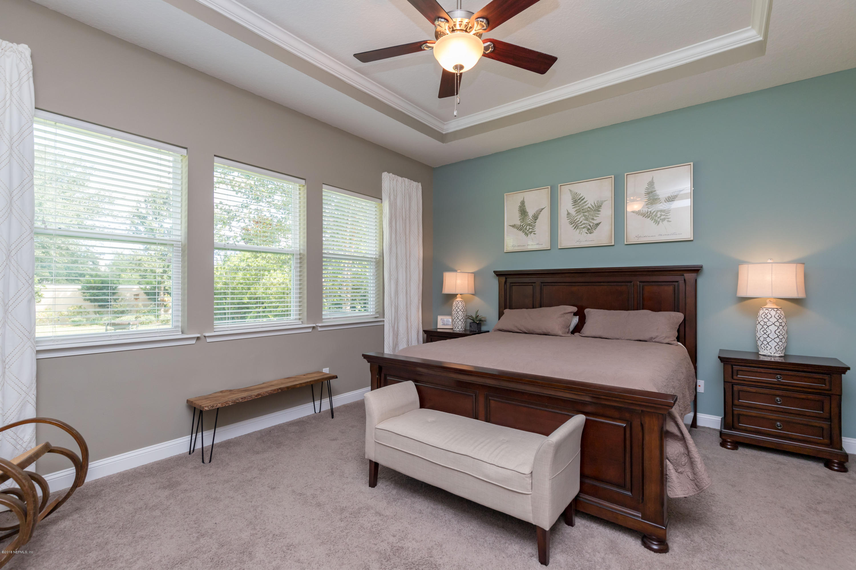 3811 Valverde Circle Jacksonville, FL 32224 - Photo 18 of 42 a bedroom with a bed and a chandelier