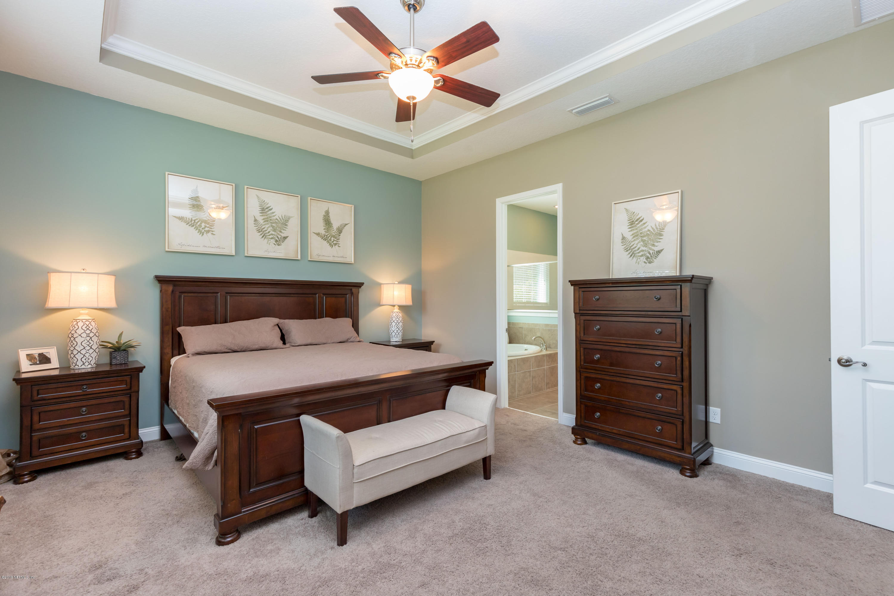 3811 Valverde Circle Jacksonville, FL 32224 - Photo 19 of 42 a bedroom with a bed and a chandelier