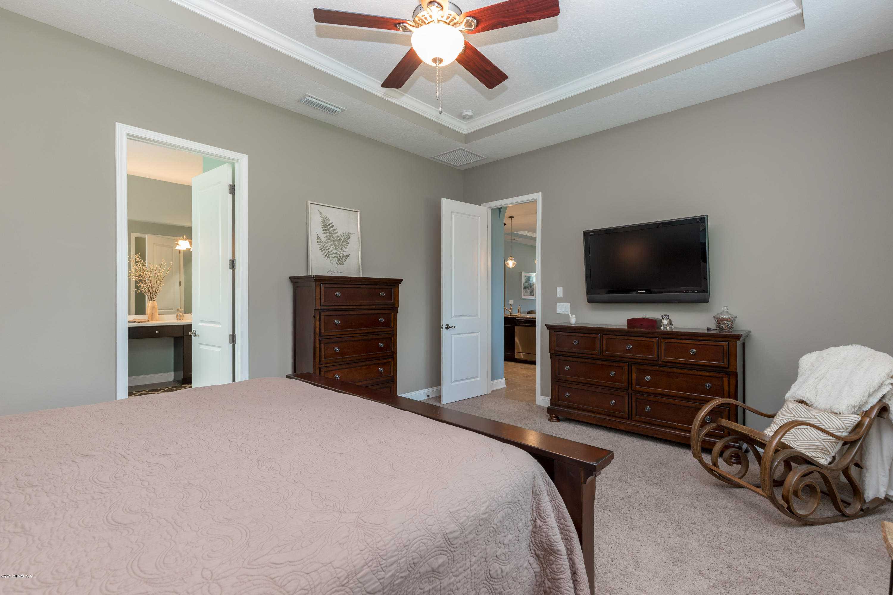 3811 Valverde Circle Jacksonville, FL 32224 - Photo 20 of 42 a bedroom with a bed and a flat screen tv
