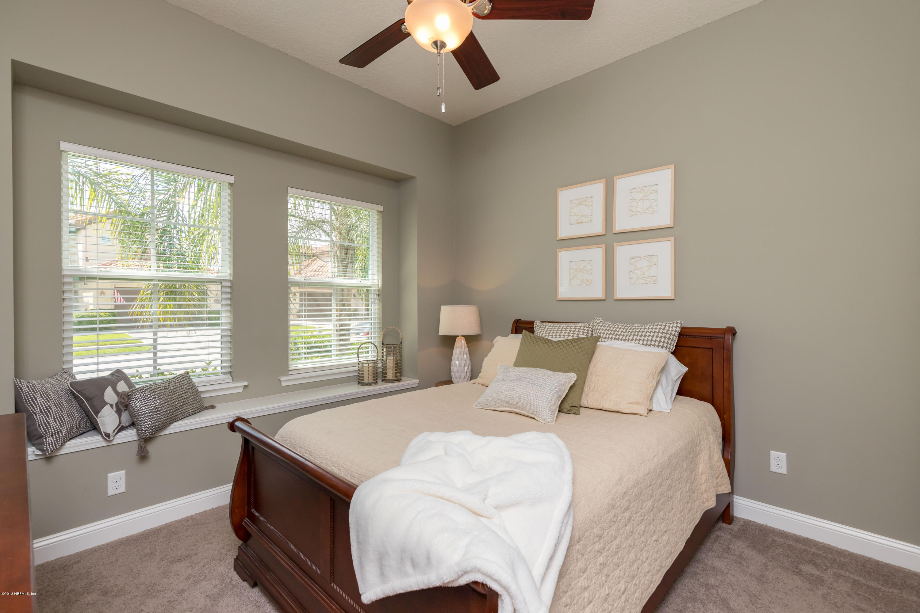 3811 Valverde Circle Jacksonville, FL 32224 - Photo 24 of 42 a bedroom with a large bed and a chandelier