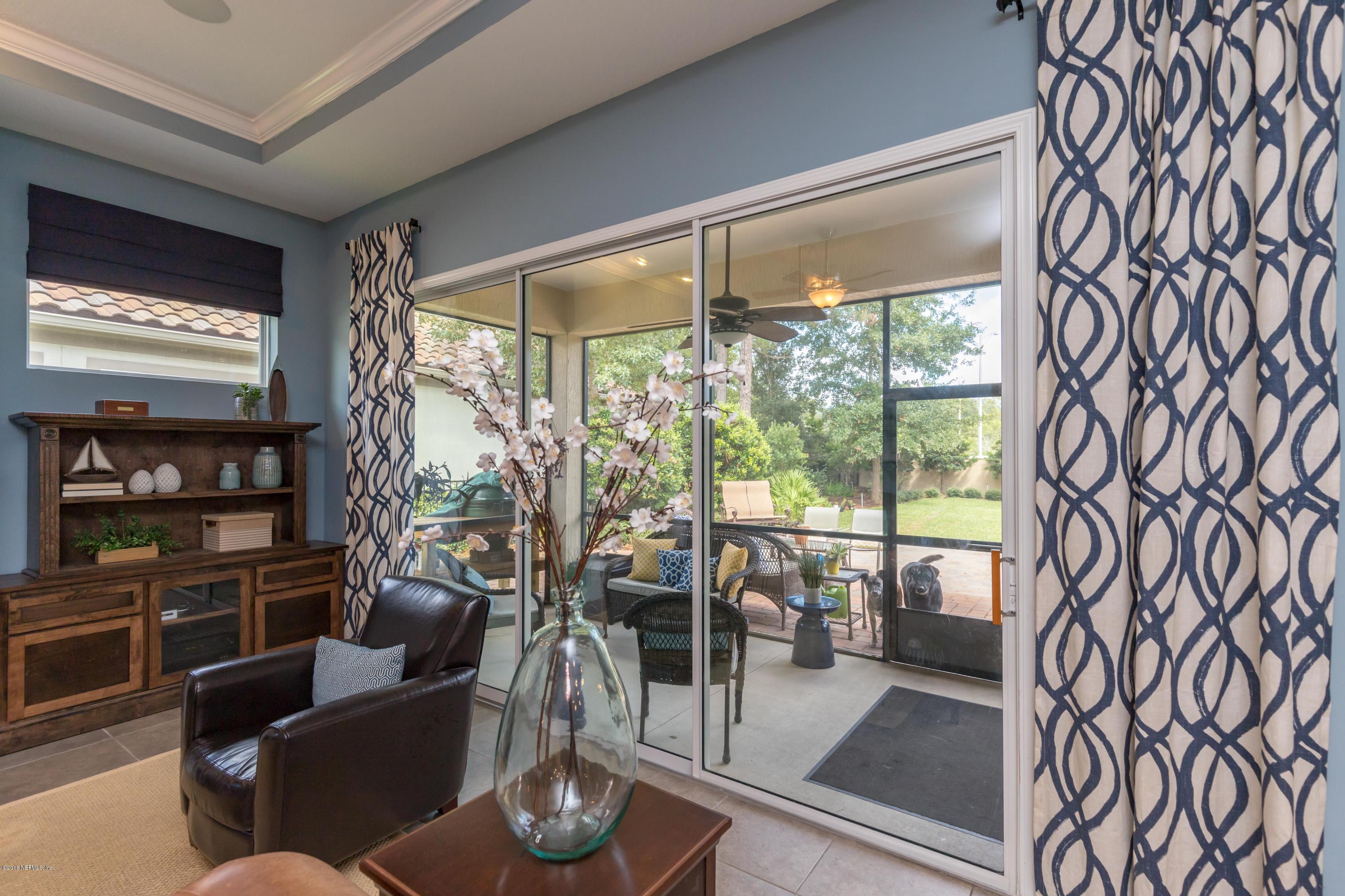 3811 Valverde Circle Jacksonville, FL 32224 - Photo 29 of 42 a living room with furniture and a floor to ceiling window