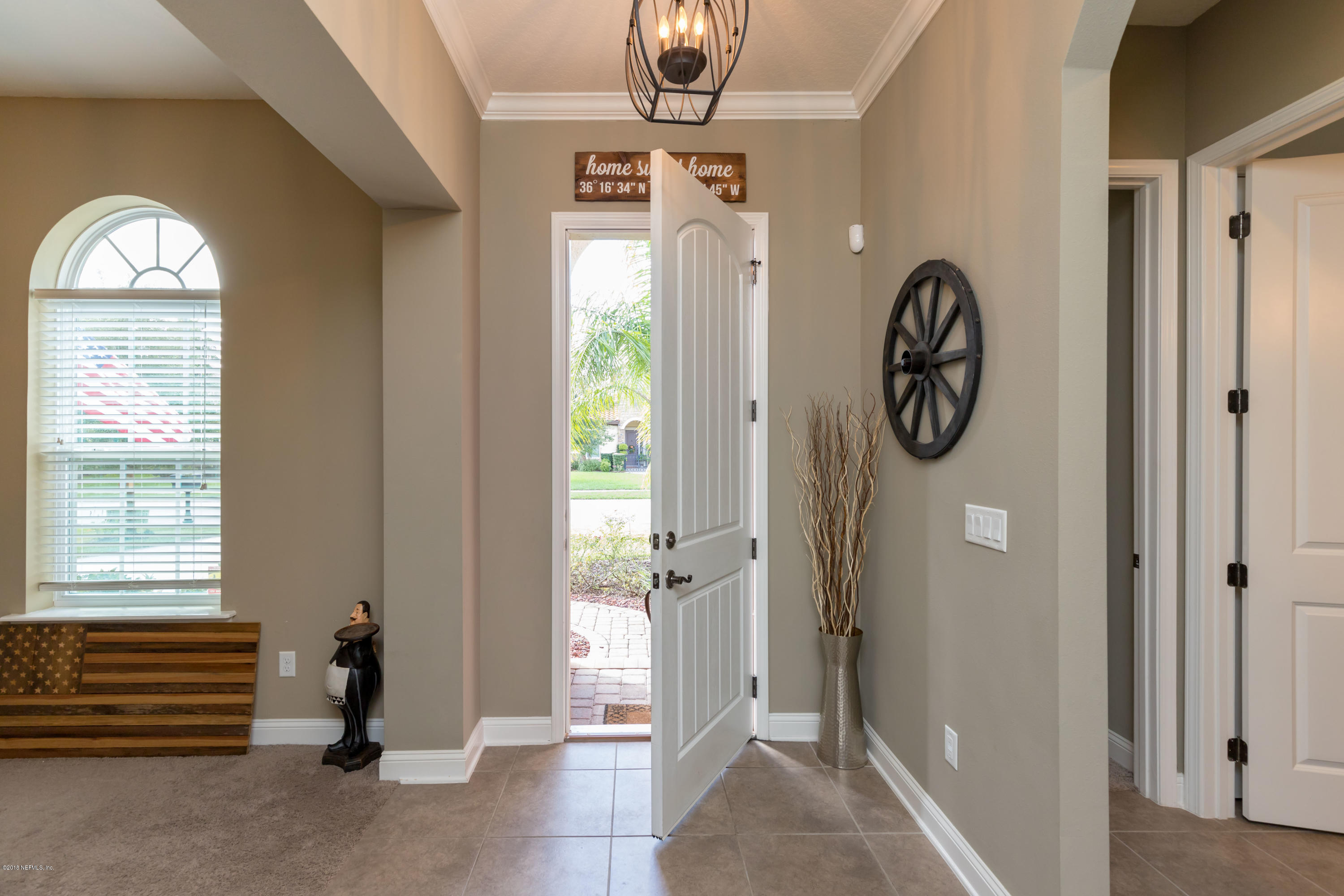 3811 Valverde Circle Jacksonville, FL 32224 - Photo 3 of 42 a view of a hallway with entryway wooden floor and front door