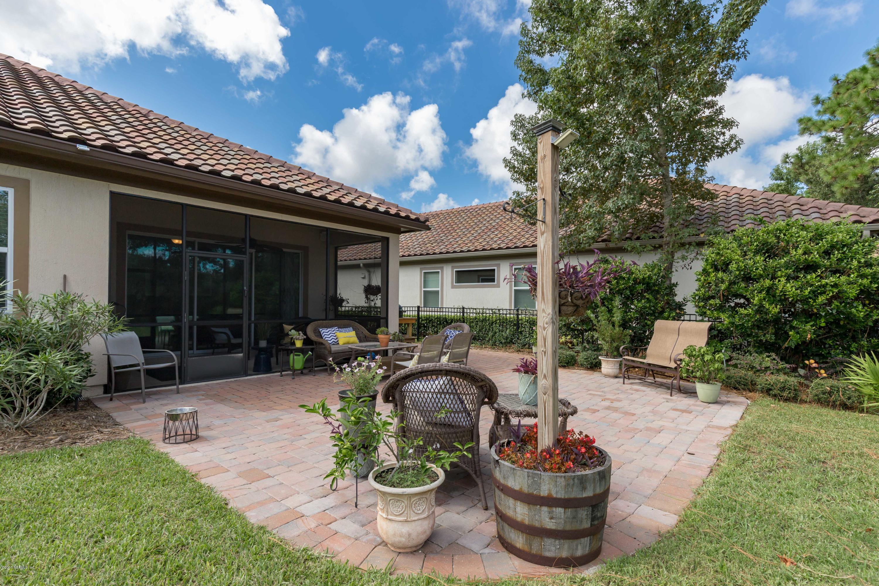 3811 Valverde Circle Jacksonville, FL 32224 - Photo 33 of 42 a view of a patio with table and chairs potted plants and a large tree