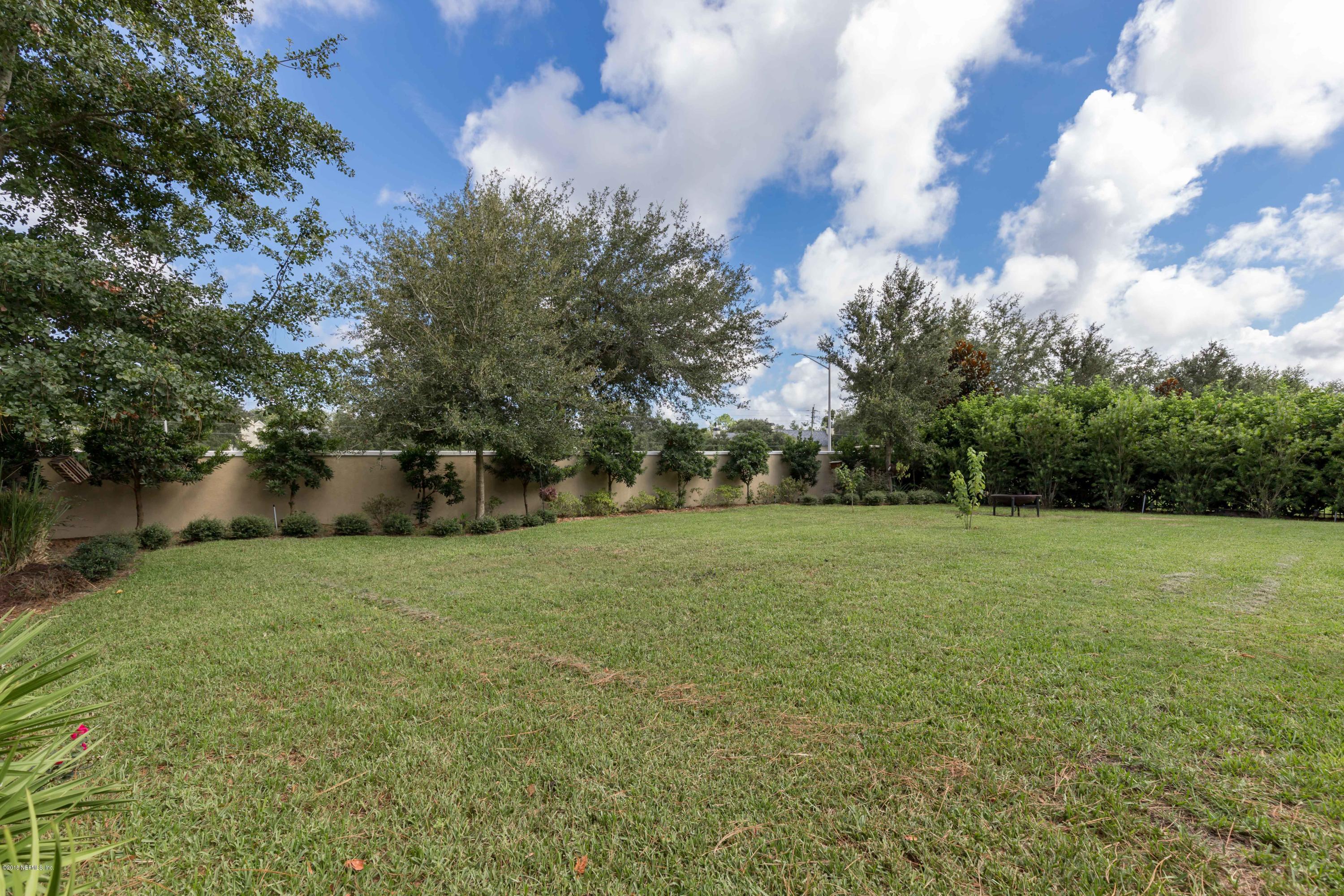 3811 Valverde Circle Jacksonville, FL 32224 - Photo 36 of 42 a view of a field of grass and trees