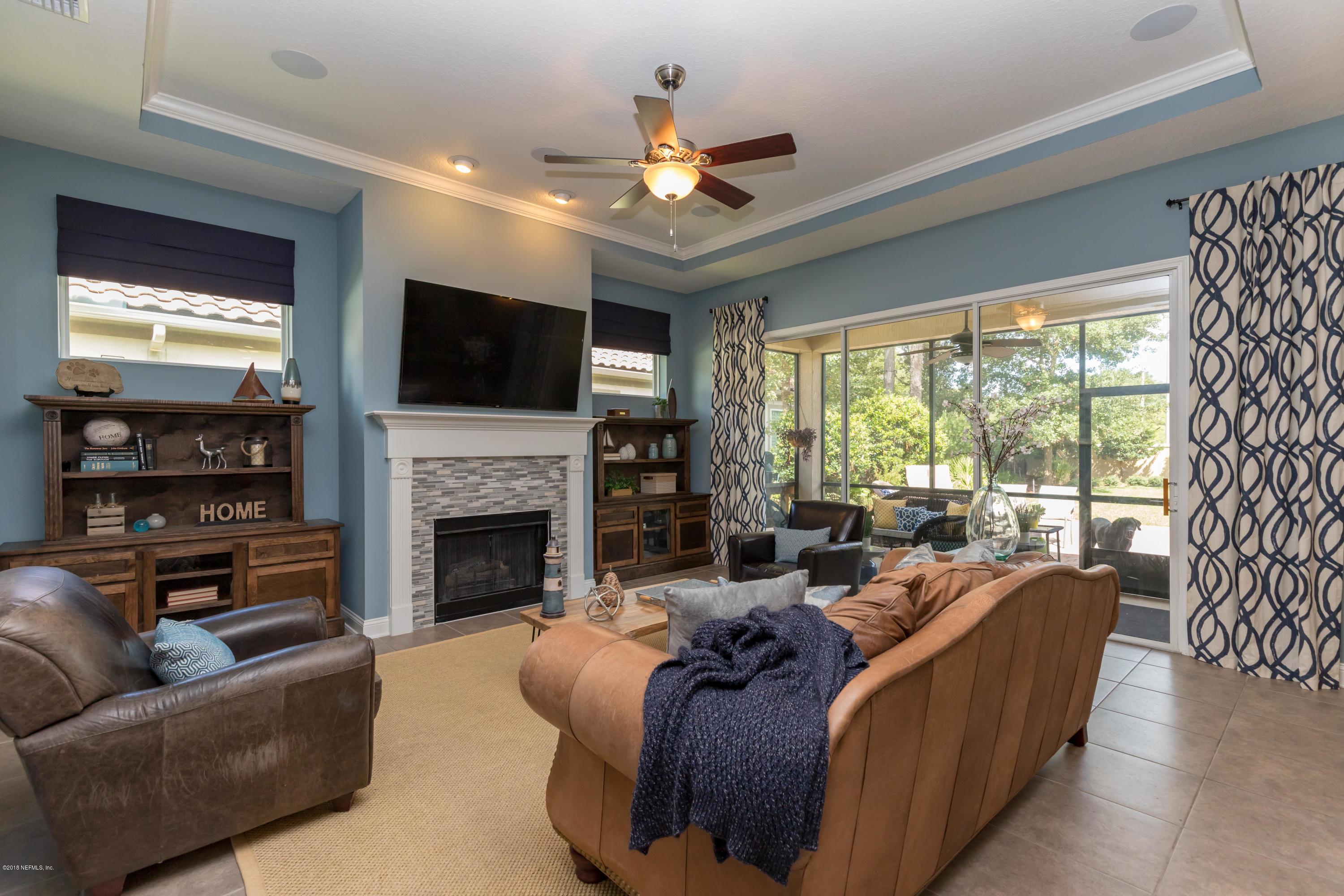 3811 Valverde Circle Jacksonville, FL 32224 - Photo 6 of 42 a living room with furniture a flat screen tv and a fireplace