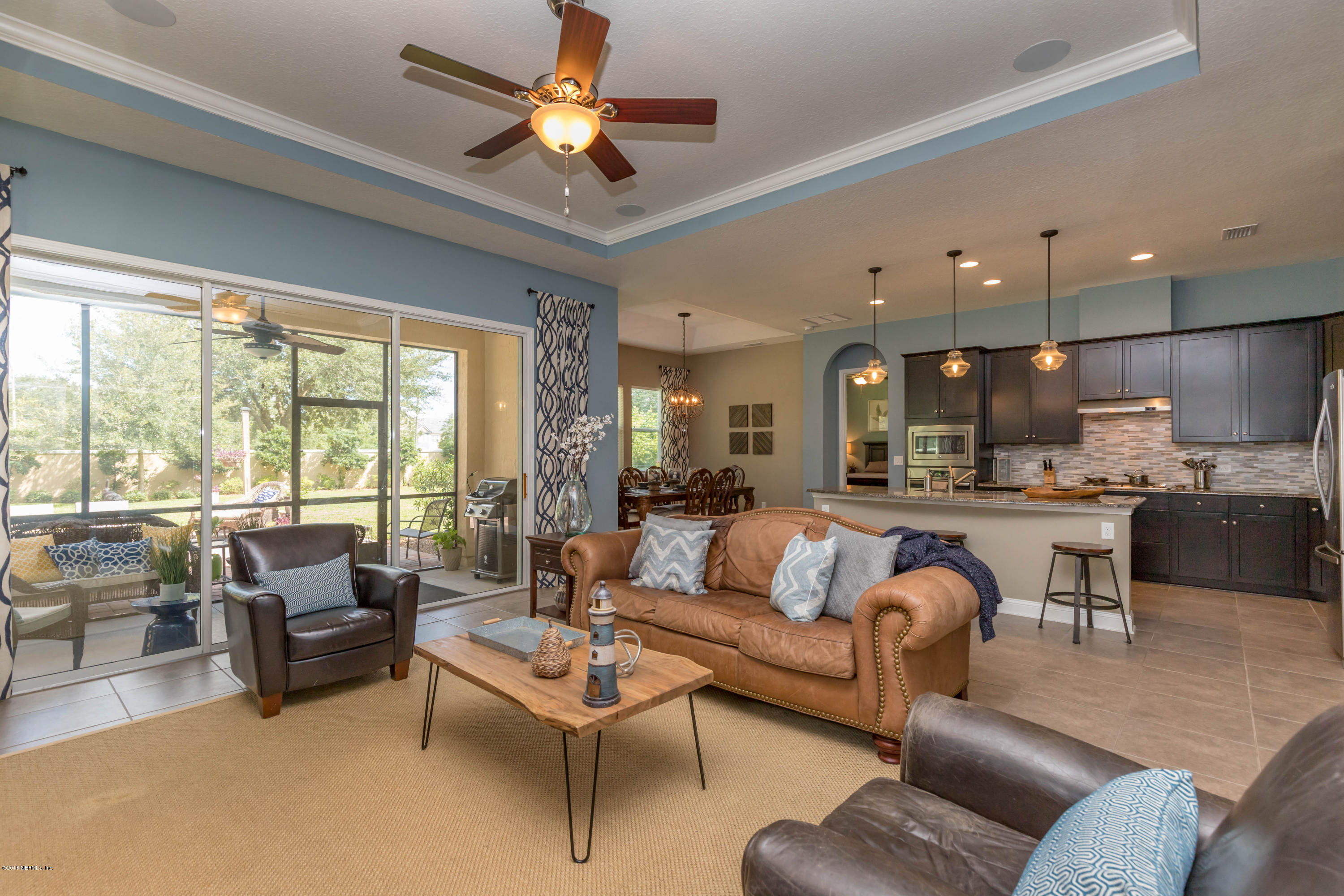 3811 Valverde Circle Jacksonville, FL 32224 - Photo 9 of 42 a living room with furniture kitchen view and a large window