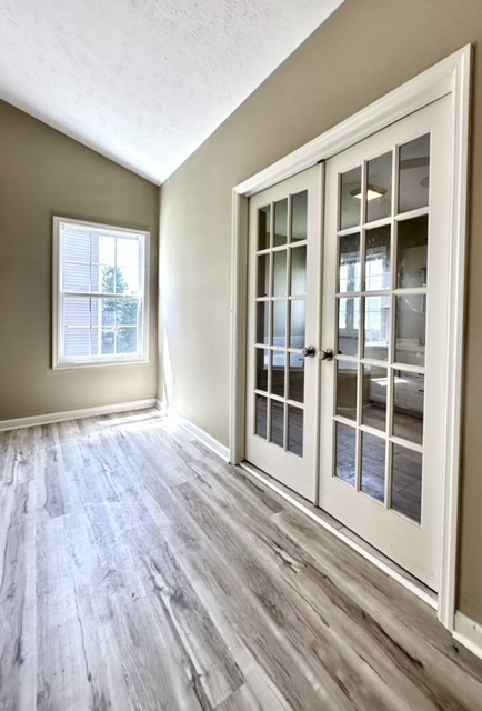 3904 Boulder Ridge Drive Champaign, IL 61822 - Photo 56 of 110 an empty room with wooden floor and windows