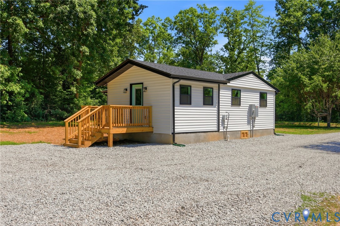 3497 Bumpass Road Beaverdam, VA 23015 - Photo 23 of 28 White siding exterior with a dark roof and a natur