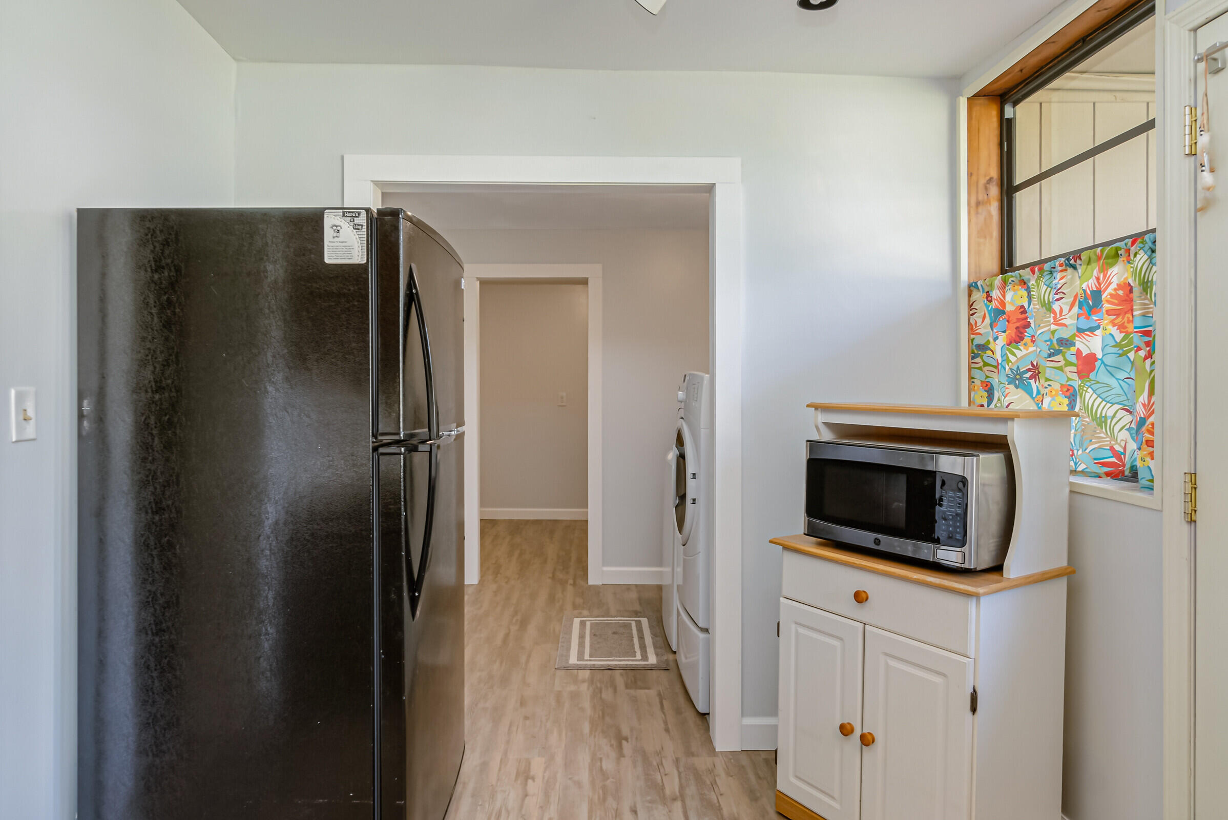 1106 Woodlawn Road Rockledge, FL 32955 - Photo 13 of 57 a kitchen with a refrigerator and cabinets